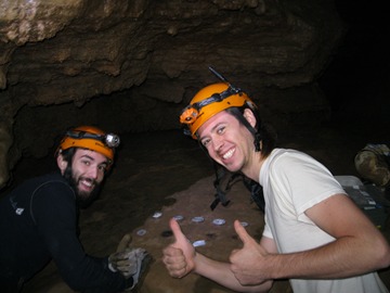 two researchers in cave with helmets and headlamps