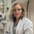 Dr. Sarah K Carmichael, Appalachian State University, in front of a transmission electron microscope